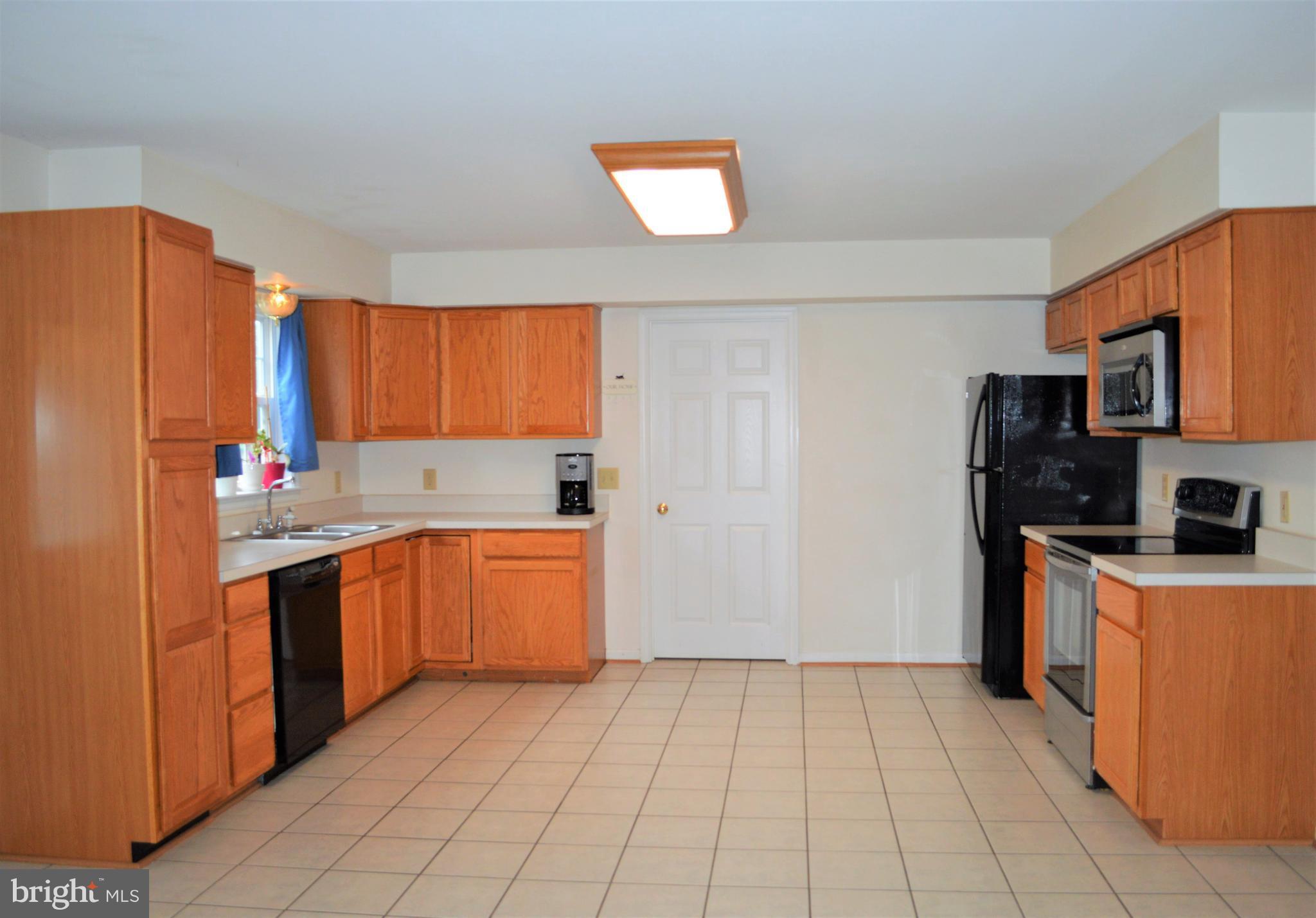 9015 Old Stillhouse Road Rixeyville, VA 22737 - Photo 6 of 21 a kitchen with stainless steel appliances granite countertop a refrigerator oven a sink dishwasher and a stove