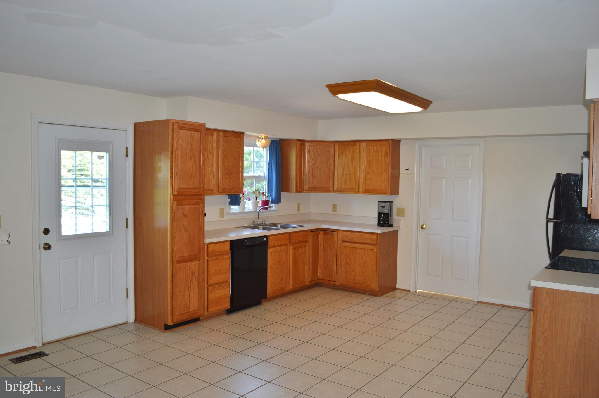 9015 Old Stillhouse Road Rixeyville, VA 22737 - Photo 7 of 21 a kitchen with stainless steel appliances granite countertop a refrigerator and a sink