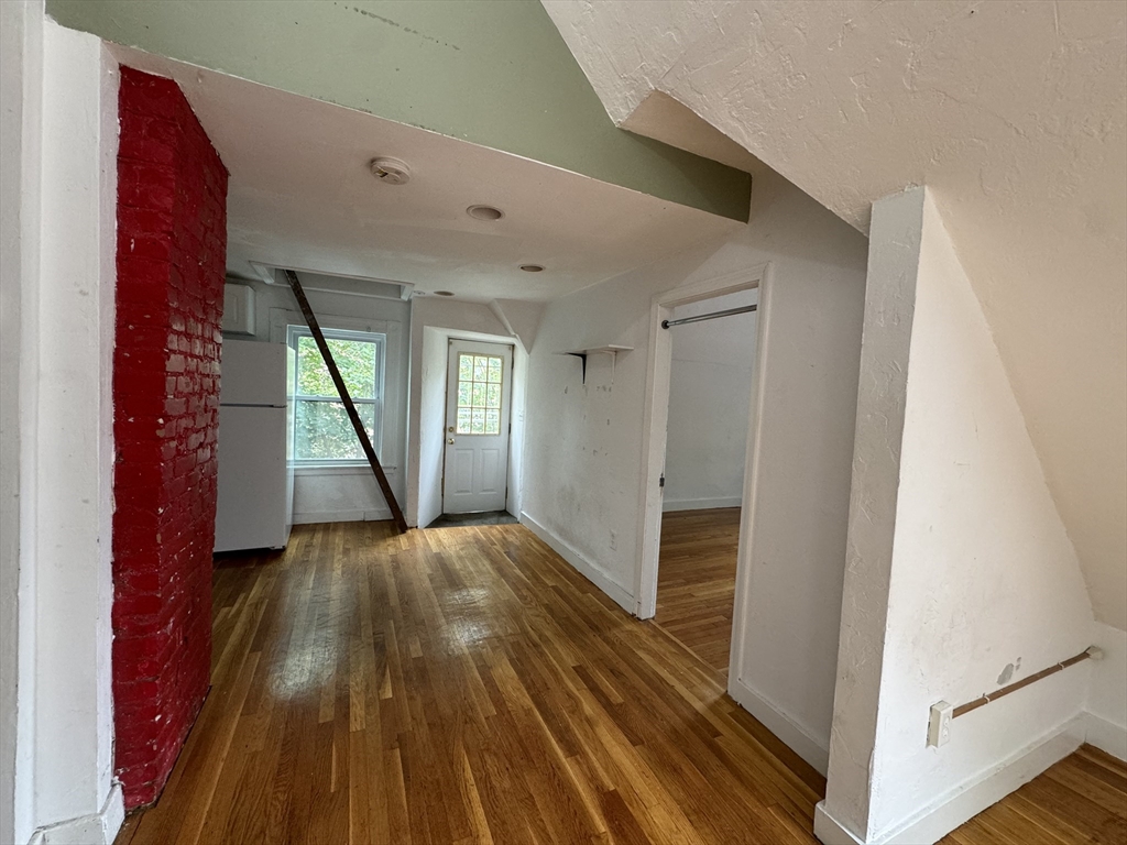 20 South Street, Unit 2 Boston, MA 02135 - Photo 3 of 21 a view of an empty room with wooden floor and a window