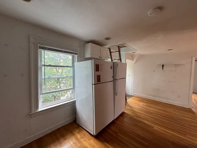 a view of kitchen with wooden floor electronic appliances and window