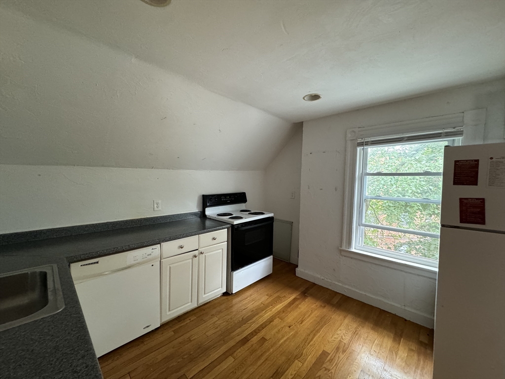 20 South Street, Unit 2 Boston, MA 02135 - Photo 10 of 21 a kitchen with a stove a sink and a window