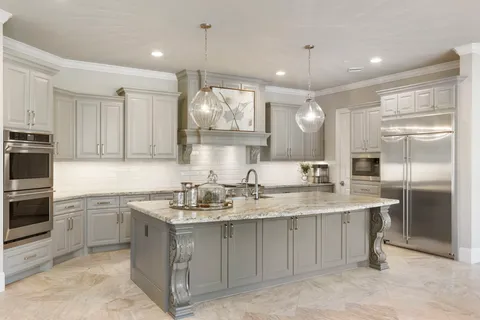 a kitchen with a sink stainless steel appliances and cabinets