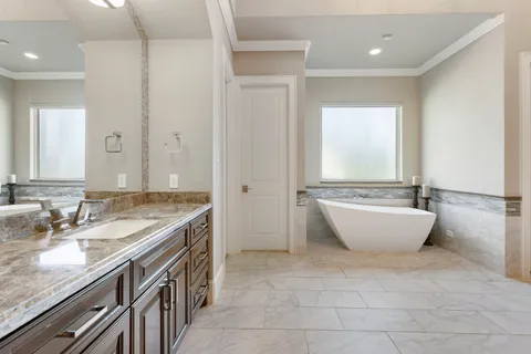 a bathroom with a granite countertop sink and mirror