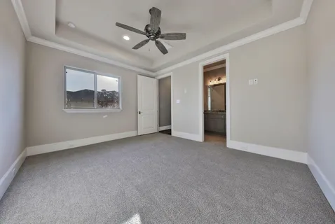 a view of a livingroom with a ceiling fan and window