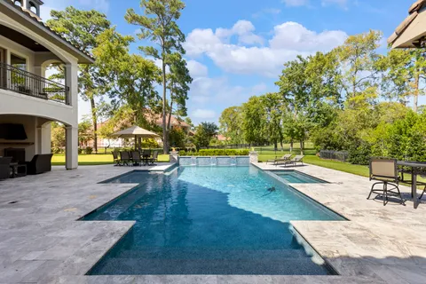 a view of a swimming pool with lounge chair