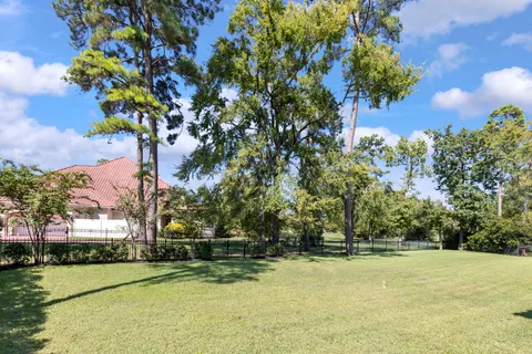 a view of swimming pool with trees and buildings in the background