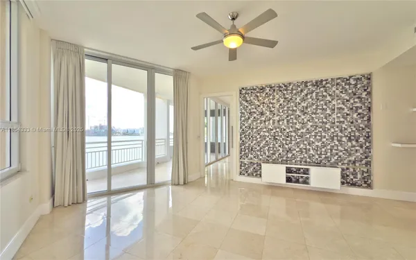 a bathroom with a granite countertop sink a toilet a large mirror a bathtub and shower