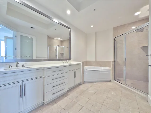 a bathroom with a shower and a glass door