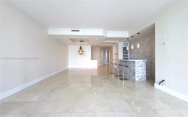 a view of a hallway with a chair and table