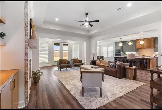 a living room with furniture and wooden floor