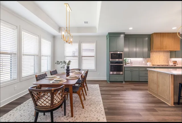 a kitchen with kitchen island granite countertop a sink cabinets and stainless steel appliances