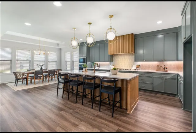 a kitchen with granite countertop a stove a sink and a cabinets