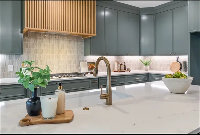 a kitchen with stainless steel appliances dining table and chairs