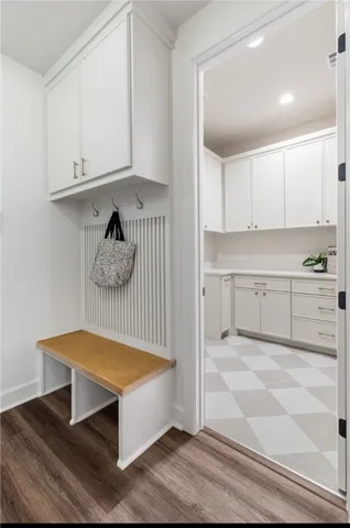 a view of a room with wooden floor and cabinets