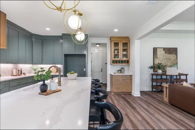 a kitchen view with wooden floor cabinets and stainless steel appliances