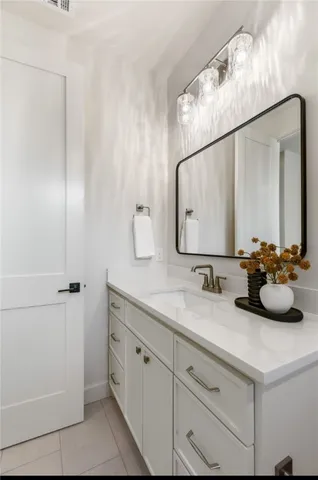 a bathroom with a double vanity sink and mirror
