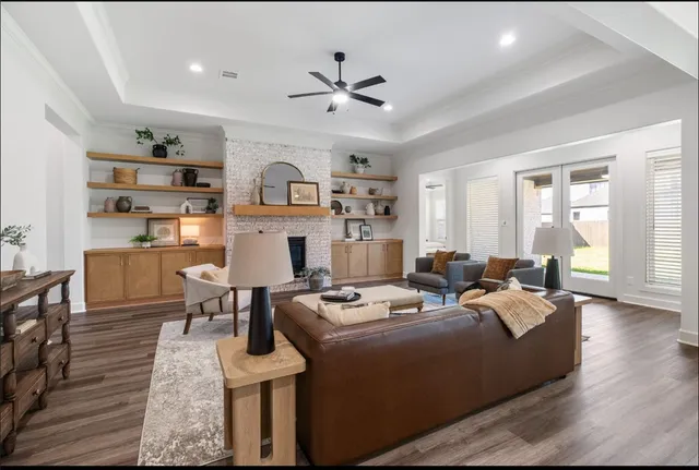 a living room with furniture a fireplace and a window