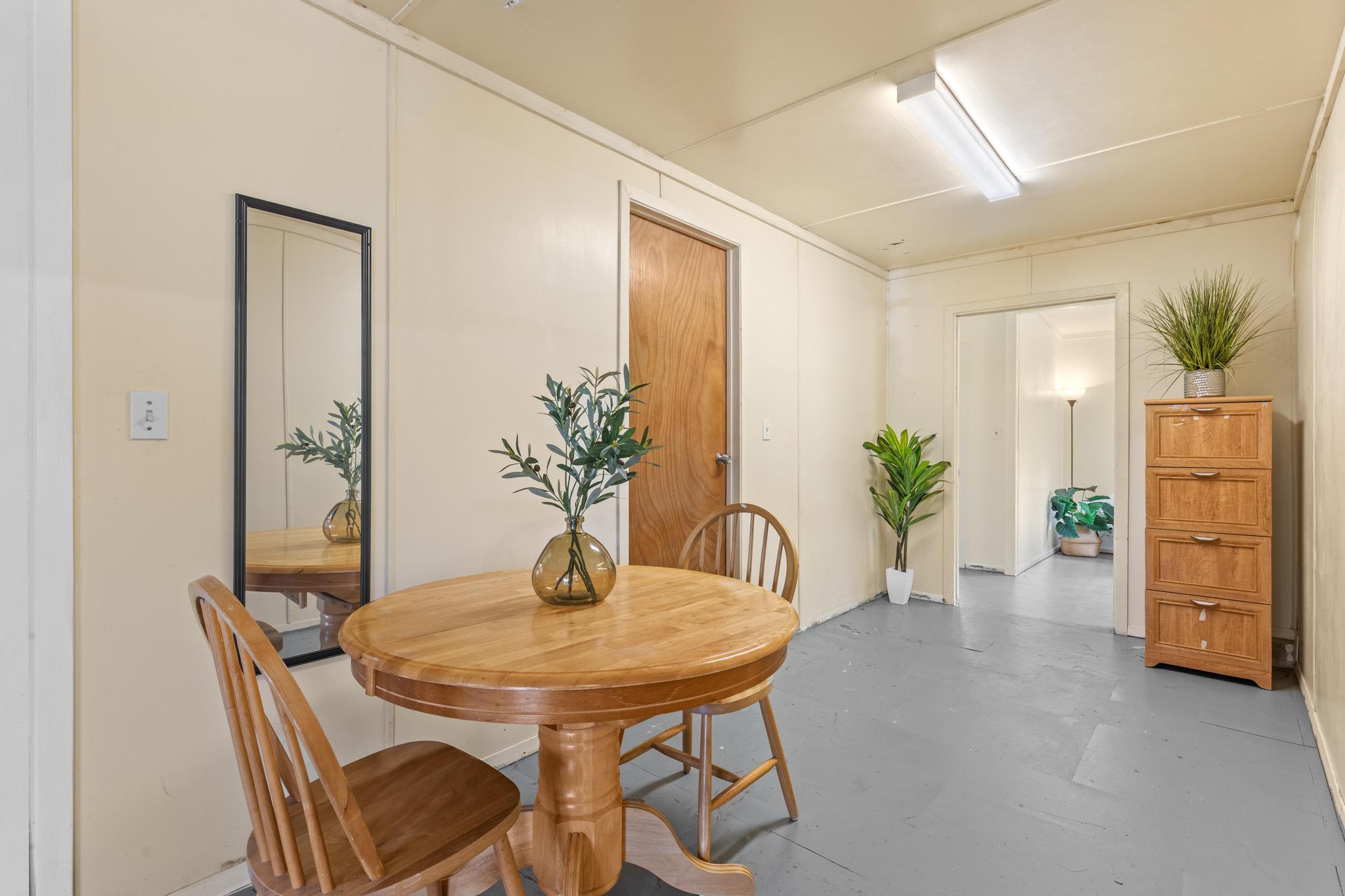 11-3681 Old Volcano Road Volcano, HI 96785 - Photo 15 of 26 a view of a dining room with furniture and wooden floor