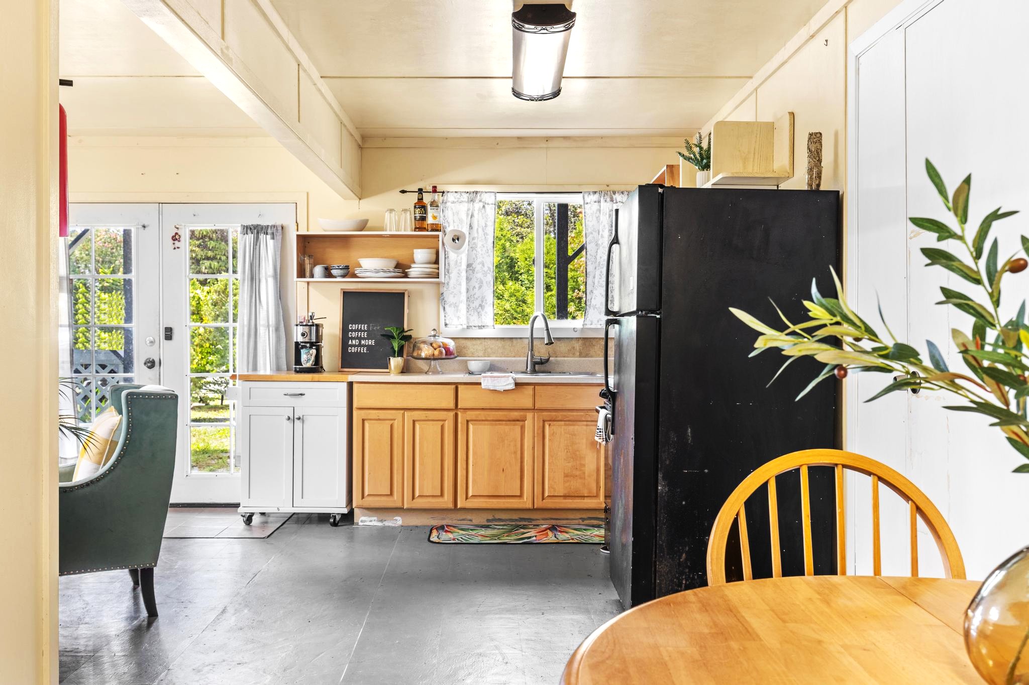 11-3681 Old Volcano Road Volcano, HI 96785 - Photo 16 of 26 a very nice looking living room with a large window a couch and a chandelier