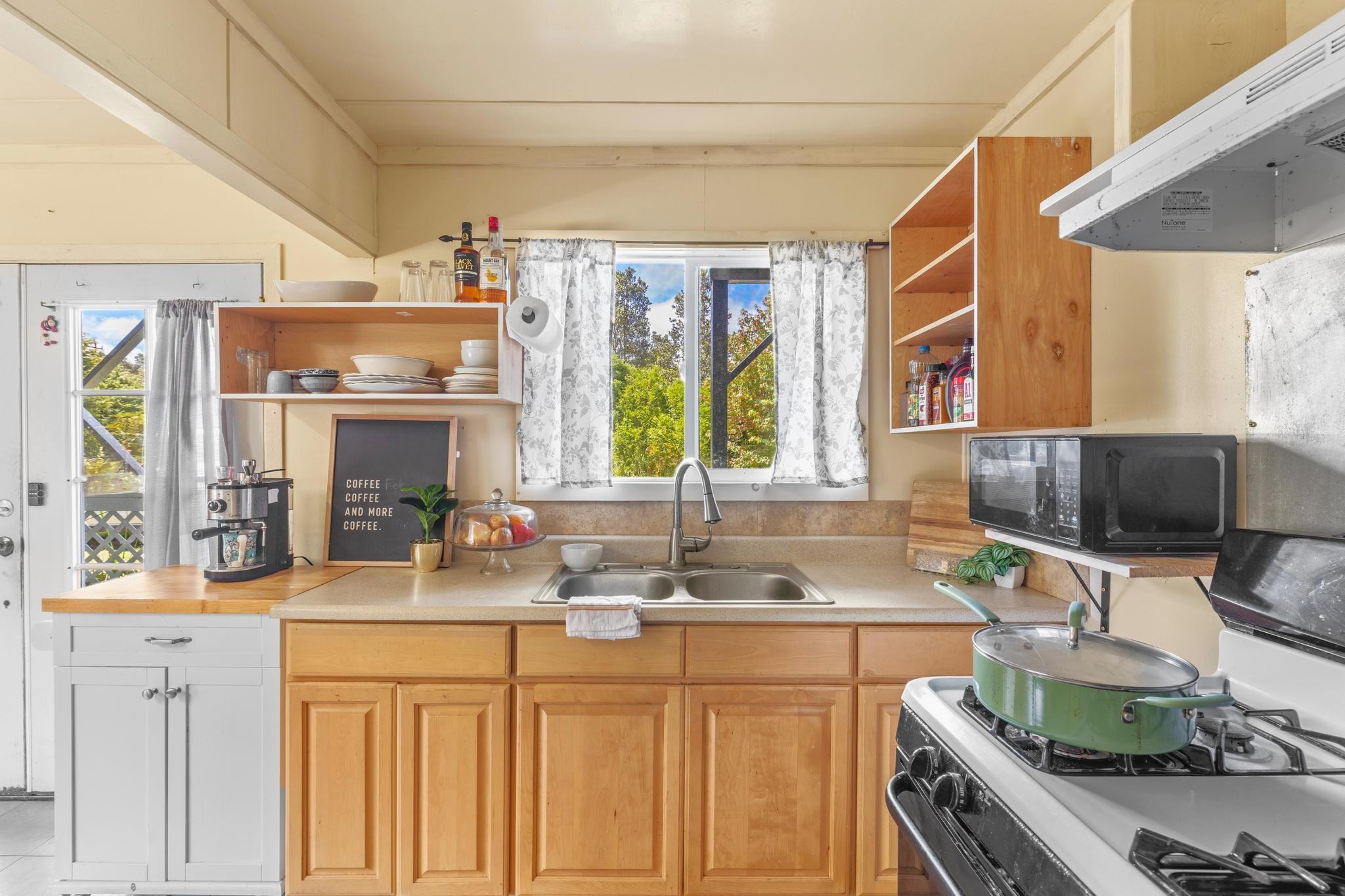11-3681 Old Volcano Road Volcano, HI 96785 - Photo 17 of 26 a kitchen with stainless steel appliances a sink stove and cabinets