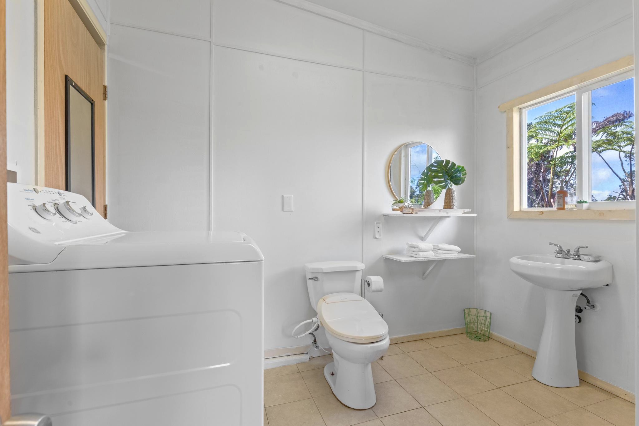 11-3681 Old Volcano Road Volcano, HI 96785 - Photo 22 of 26 a white toilet sitting next to a bathroom sink