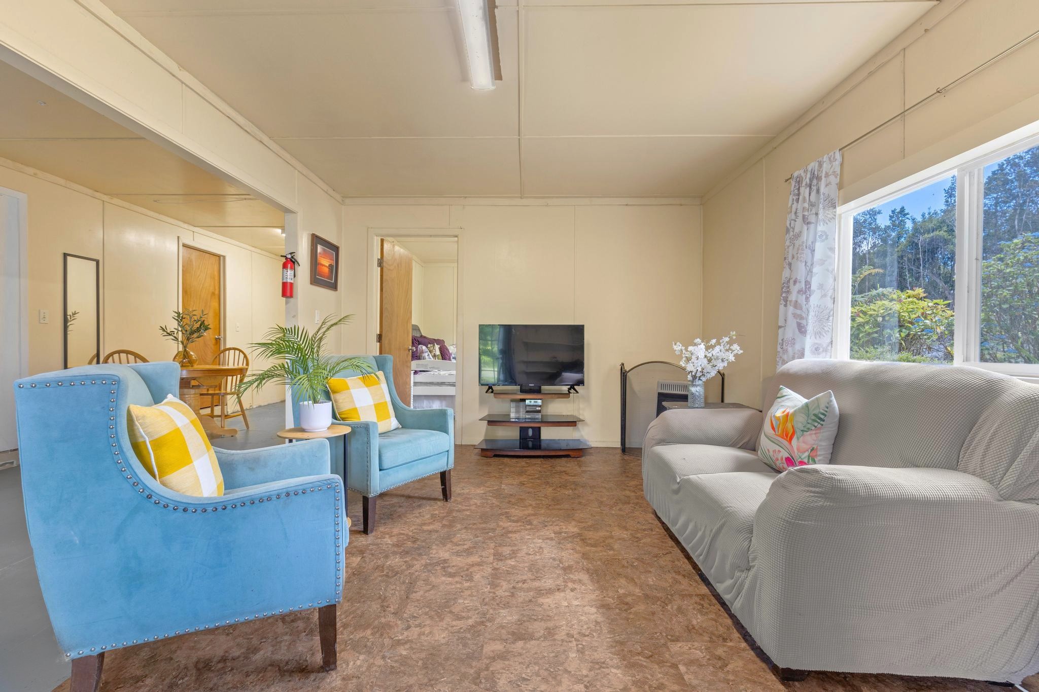11-3681 Old Volcano Road Volcano, HI 96785 - Photo 23 of 26 a living room with furniture and a flat screen tv