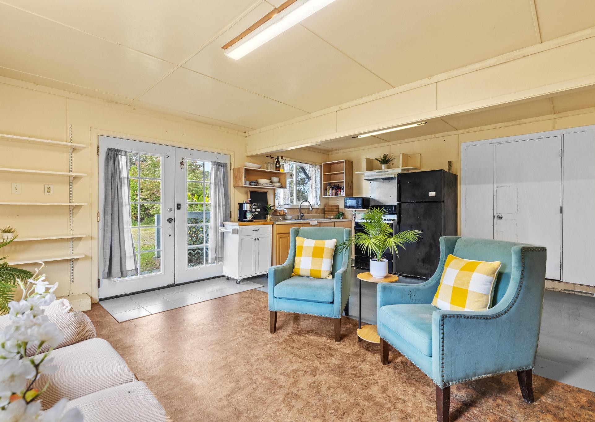 11-3681 Old Volcano Road Volcano, HI 96785 - Photo 24 of 26 a living room with furniture and a floor to ceiling window