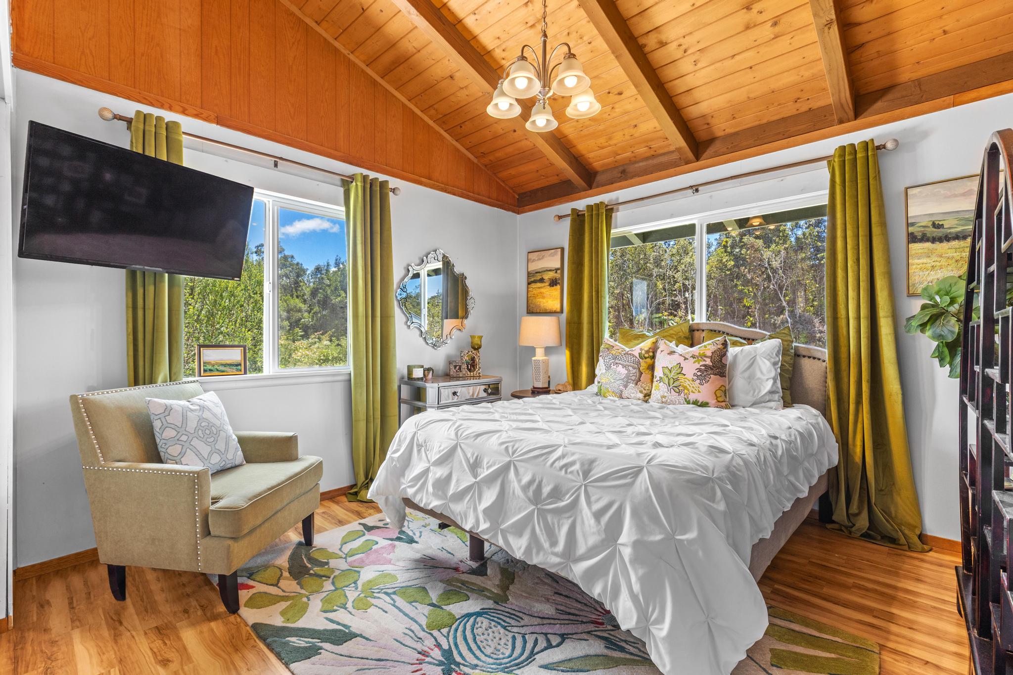11-3681 Old Volcano Road Volcano, HI 96785 - Photo 3 of 26 a bedroom with a bed and wooden floor