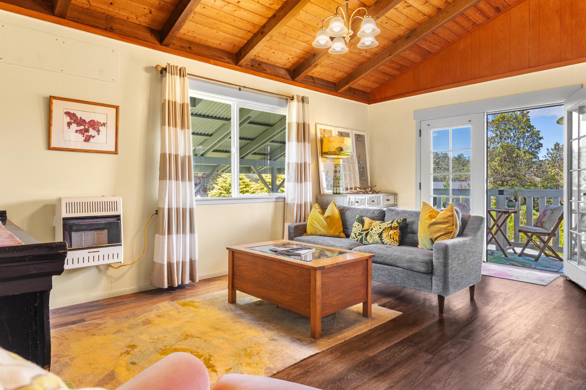 11-3681 Old Volcano Road Volcano, HI 96785 - Photo 7 of 26 a living room with furniture windows and wooden floor