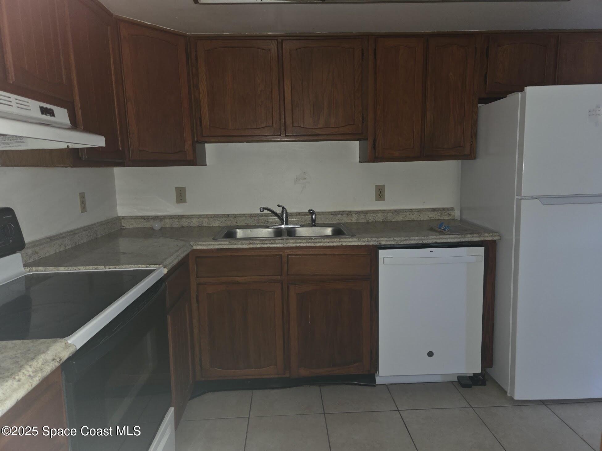 255 Kings Way Satellite Beach, FL 32937 - Photo 12 of 34 a kitchen with a sink and cabinets