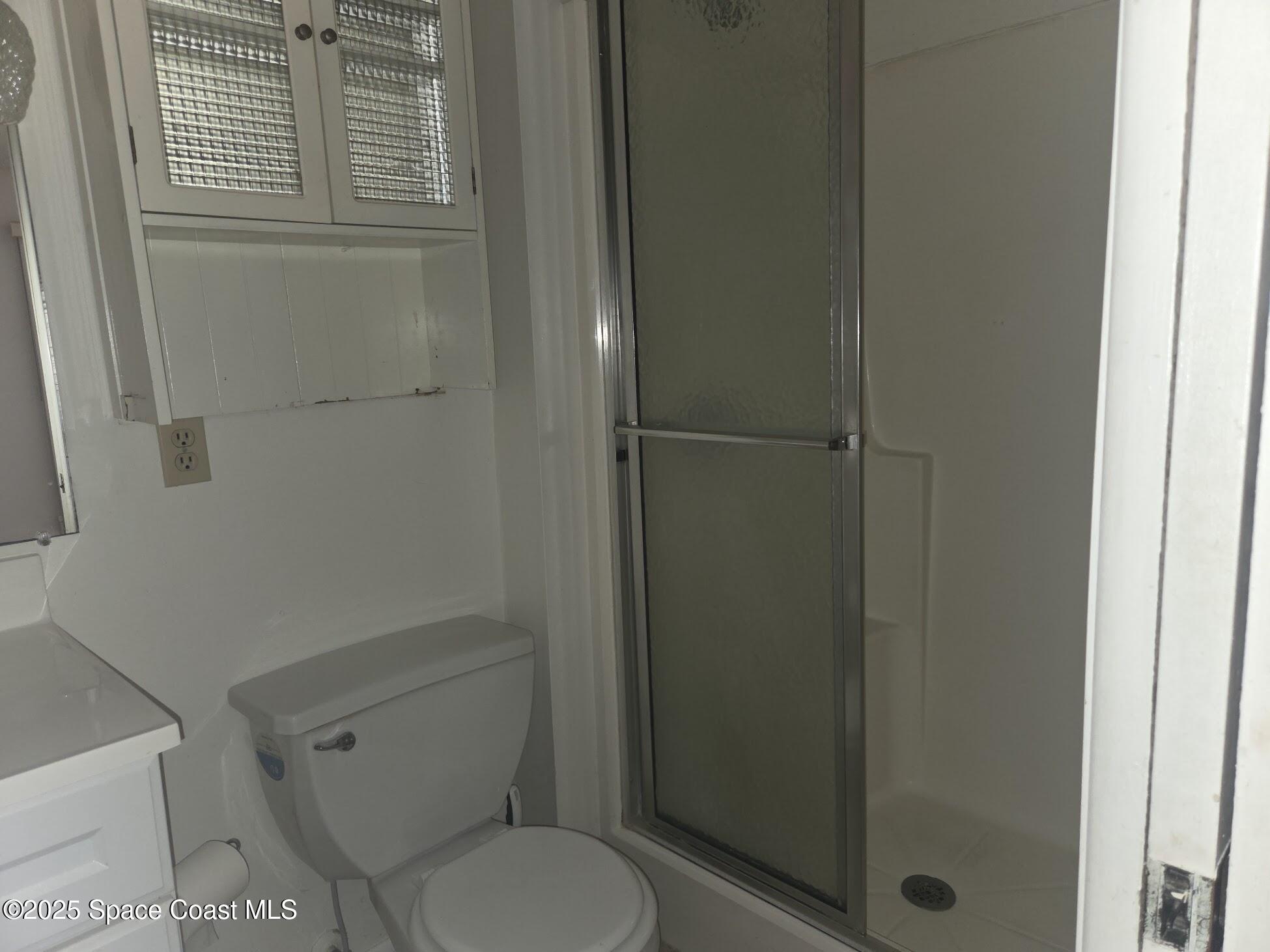 255 Kings Way Satellite Beach, FL 32937 - Photo 21 of 34 a white toilet sitting next to a bathroom sink