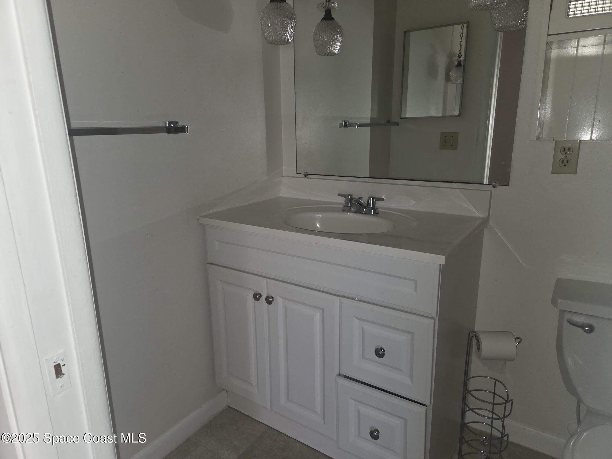 255 Kings Way Satellite Beach, FL 32937 - Photo 26 of 34 a bathroom with a sink toilet and mirror