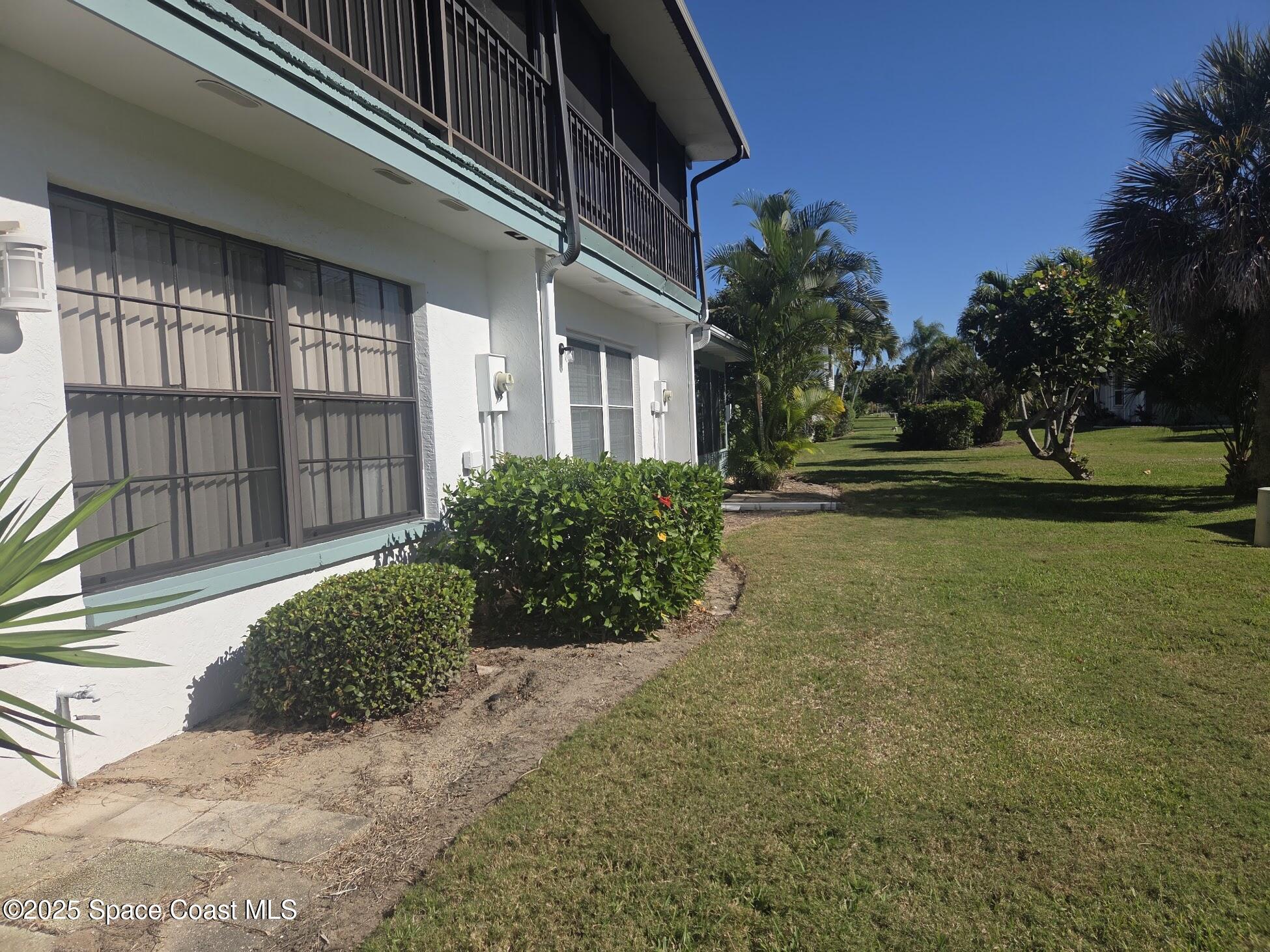 255 Kings Way Satellite Beach, FL 32937 - Photo 8 of 34 a view of a house with a yard and pathway