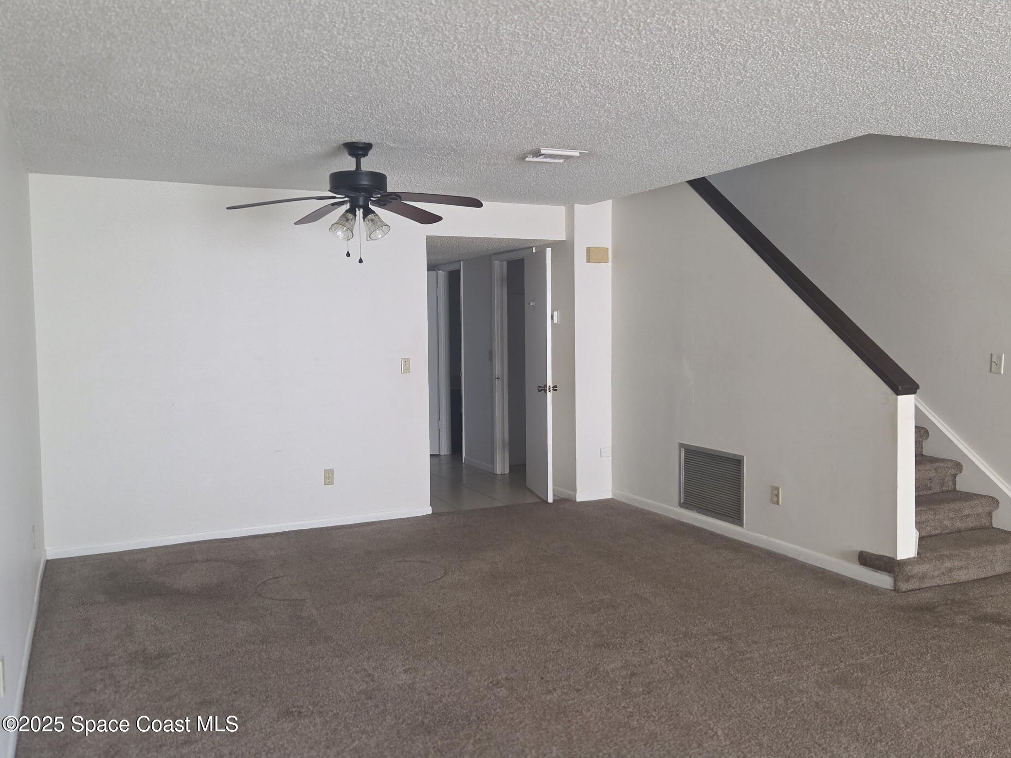 255 Kings Way Satellite Beach, FL 32937 - Photo 10 of 34 a view of a big room with carpet