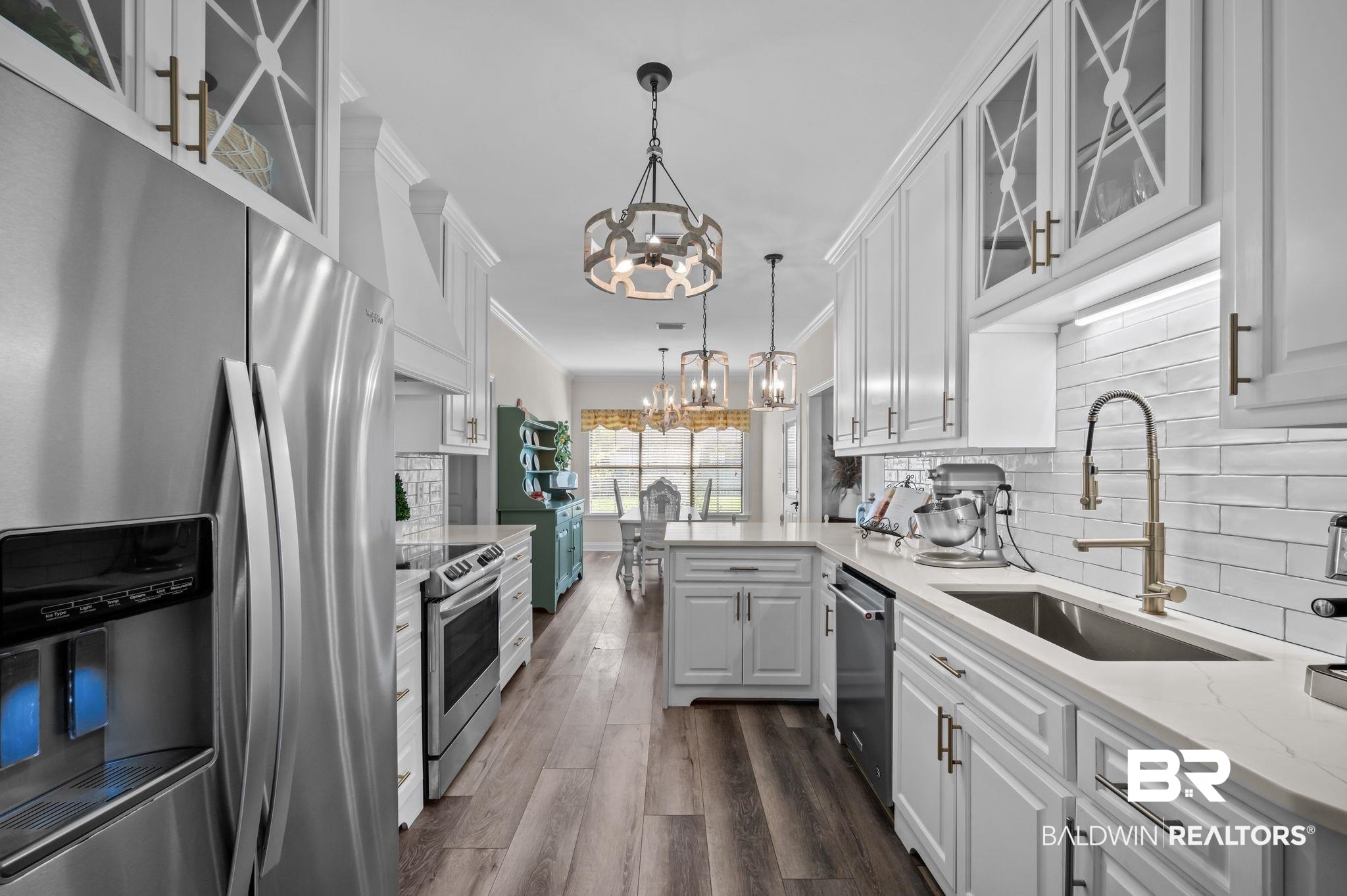 9837 Harmony Ridge Drive Semmes, AL 36575 - Photo 15 of 29 Kitchen featuring white cabinetry, a sink, stainless steel appliances, and an inviting chandelier