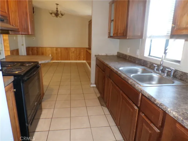 a kitchen with a stove a refrigerator and cabinets