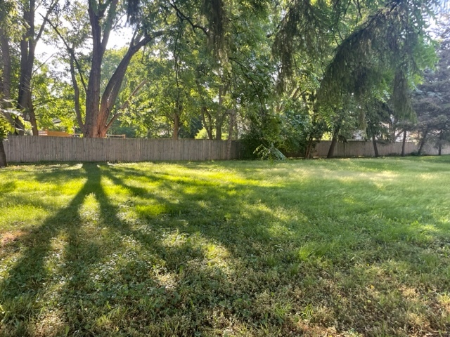 a view of yard with swimming pool and trees