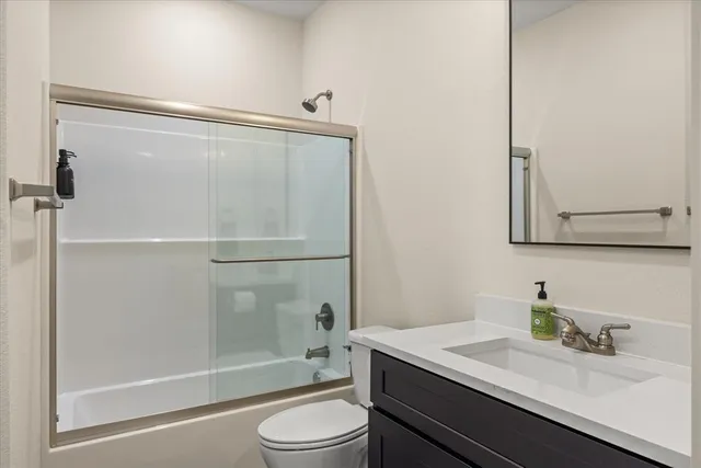 a bathroom with a toilet a sink and a mirror
