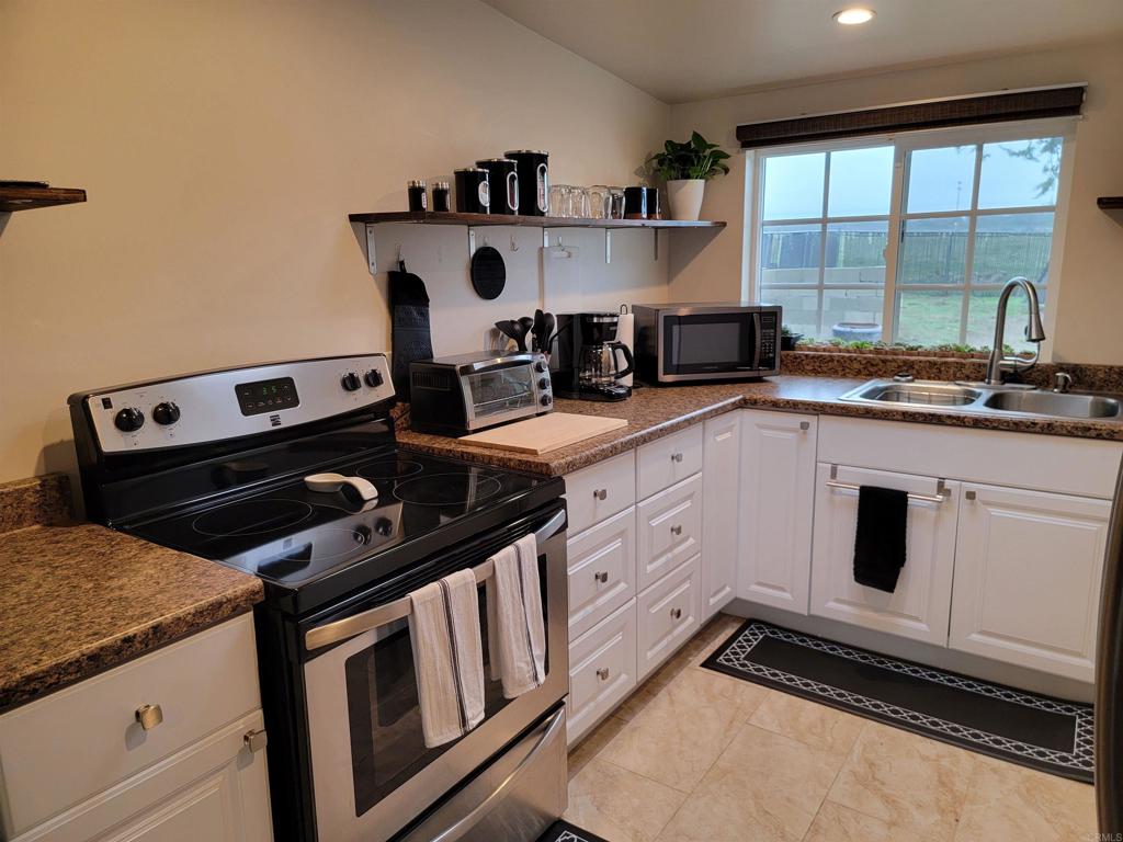 37304 Montezuma Valley Road Ranchita, CA 92066 - Photo 12 of 35 a kitchen with a stove and white cabinets