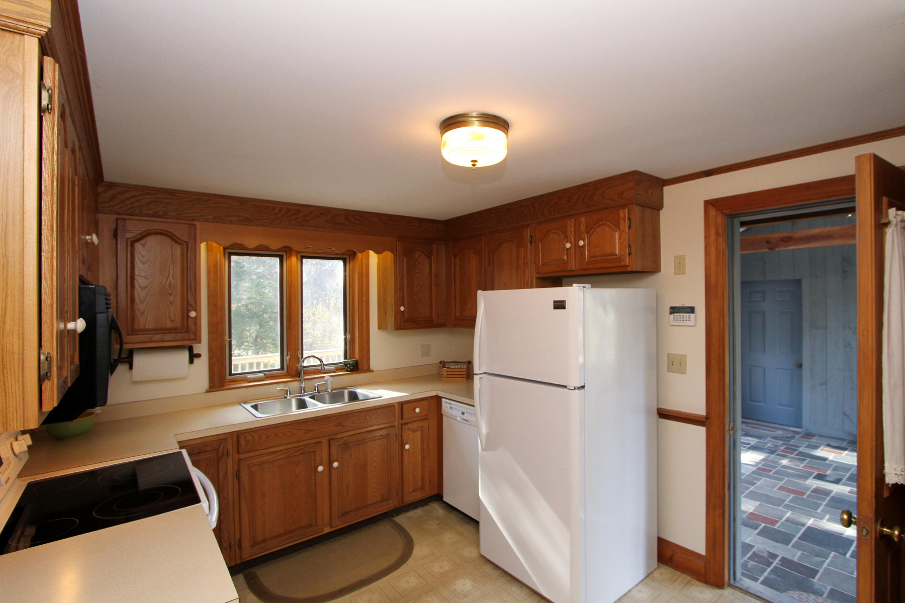 45 Doane Road Harwich Port, MA 02646 - Photo 12 of 35 a kitchen with refrigerator a stove a sink dishwasher and wooden cabinets with wooden floor