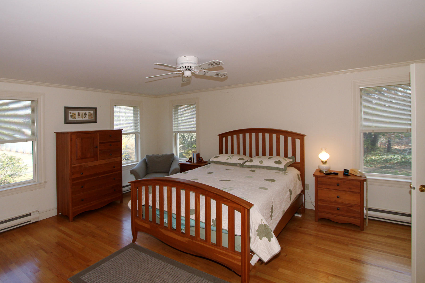 45 Doane Road Harwich Port, MA 02646 - Photo 13 of 35 a bedroom with a bed and a chandelier