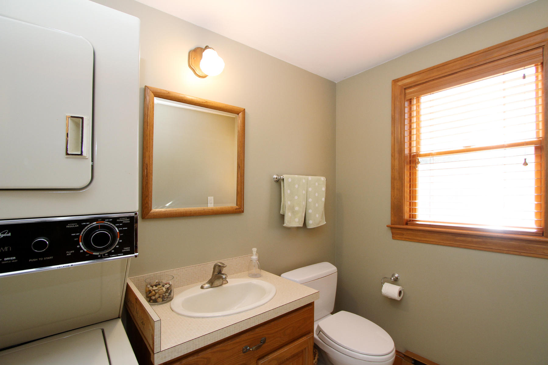 45 Doane Road Harwich Port, MA 02646 - Photo 18 of 35 a bathroom with a toilet a sink a mirror and a window