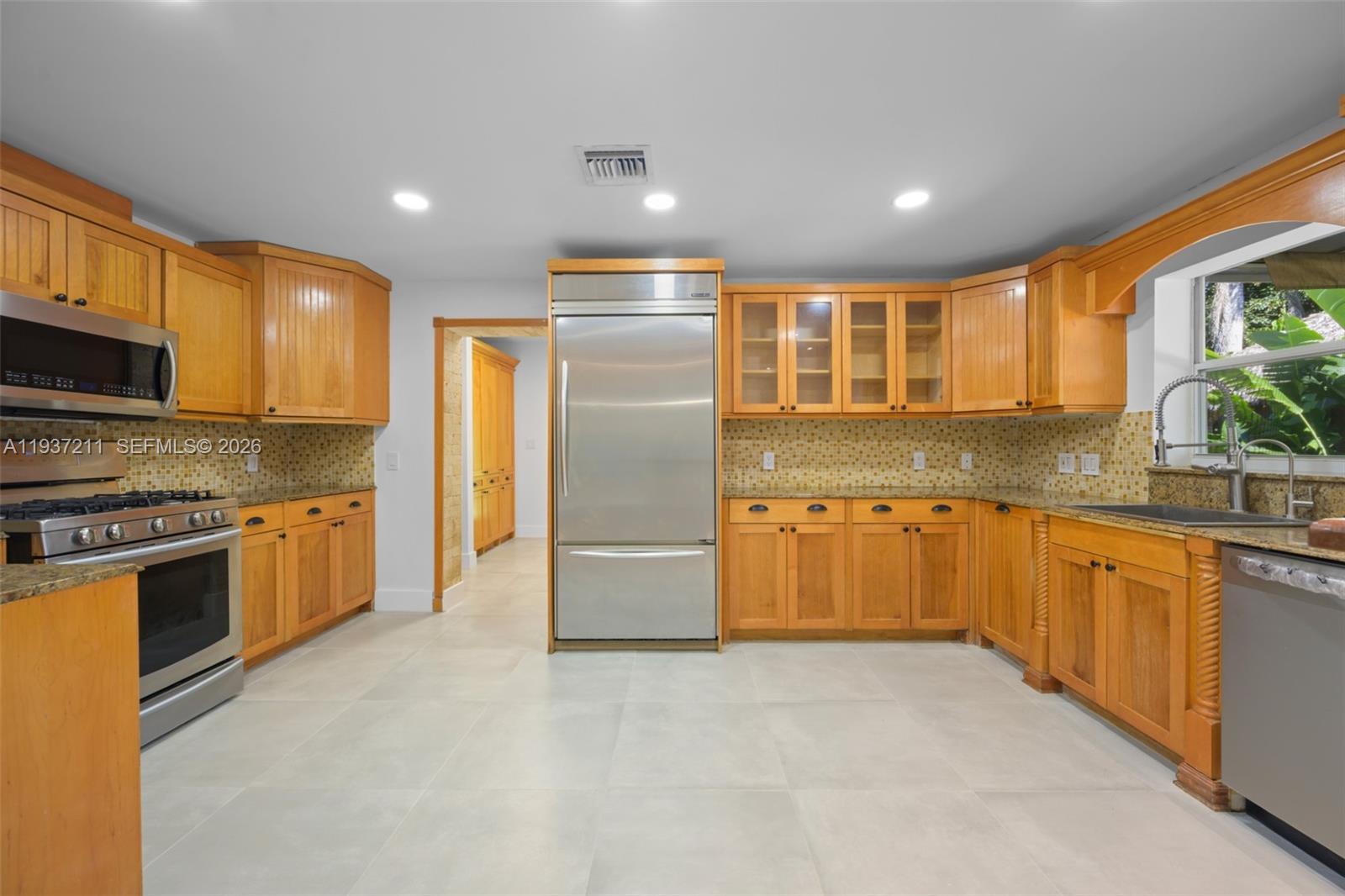 5300 Southwest 162nd Avenue Southwest Ranches, FL 33331 - Photo 14 of 43 a large kitchen with stainless steel appliances granite countertop a refrigerator and a stove top oven