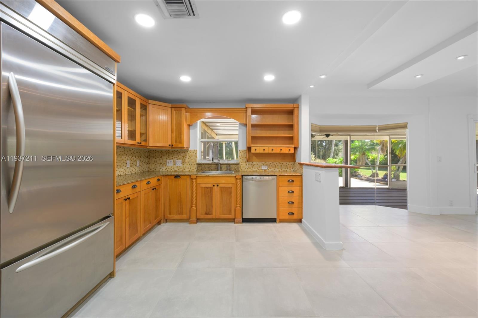 5300 Southwest 162nd Avenue Southwest Ranches, FL 33331 - Photo 15 of 43 a large kitchen with stainless steel appliances granite countertop a refrigerator and a sink