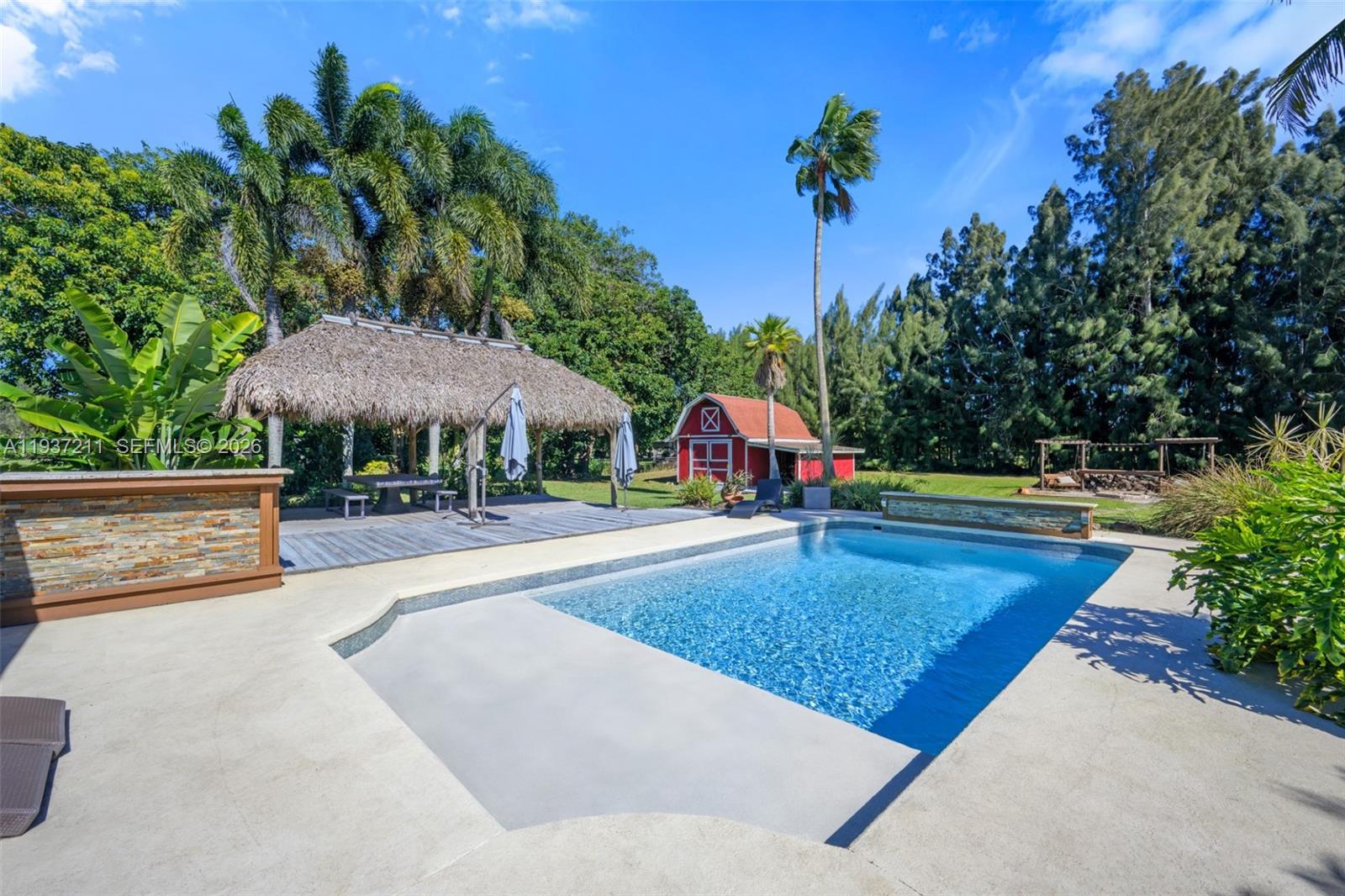 5300 Southwest 162nd Avenue Southwest Ranches, FL 33331 - Photo 33 of 43 a swimming pool with outdoor seating and yard