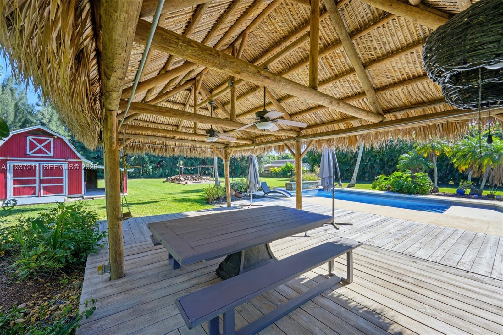 5300 Southwest 162nd Avenue Southwest Ranches, FL 33331 - Photo 35 of 43 a view of a patio with table and chairs under an umbrella
