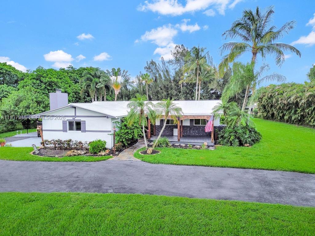 5300 Southwest 162nd Avenue Southwest Ranches, FL 33331 - Photo 5 of 43 a view of a house with a yard and potted plants
