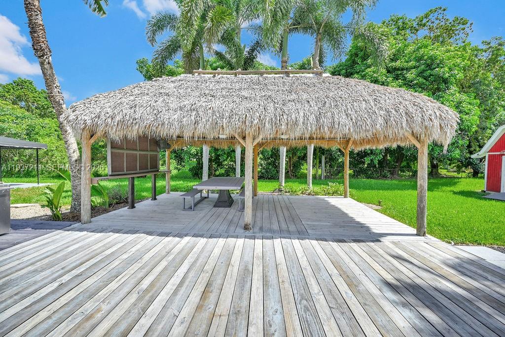 5300 Southwest 162nd Avenue Southwest Ranches, FL 33331 - Photo 6 of 43 a view of a patio with a table chairs potted plants and a palm tree