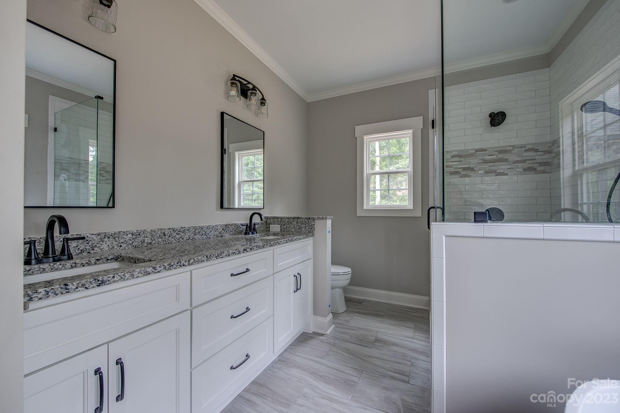 2911 Sparrow Springs Road Gastonia, NC 28052 - Photo 20 of 31 a bathroom with a granite countertop sink mirror and toilet