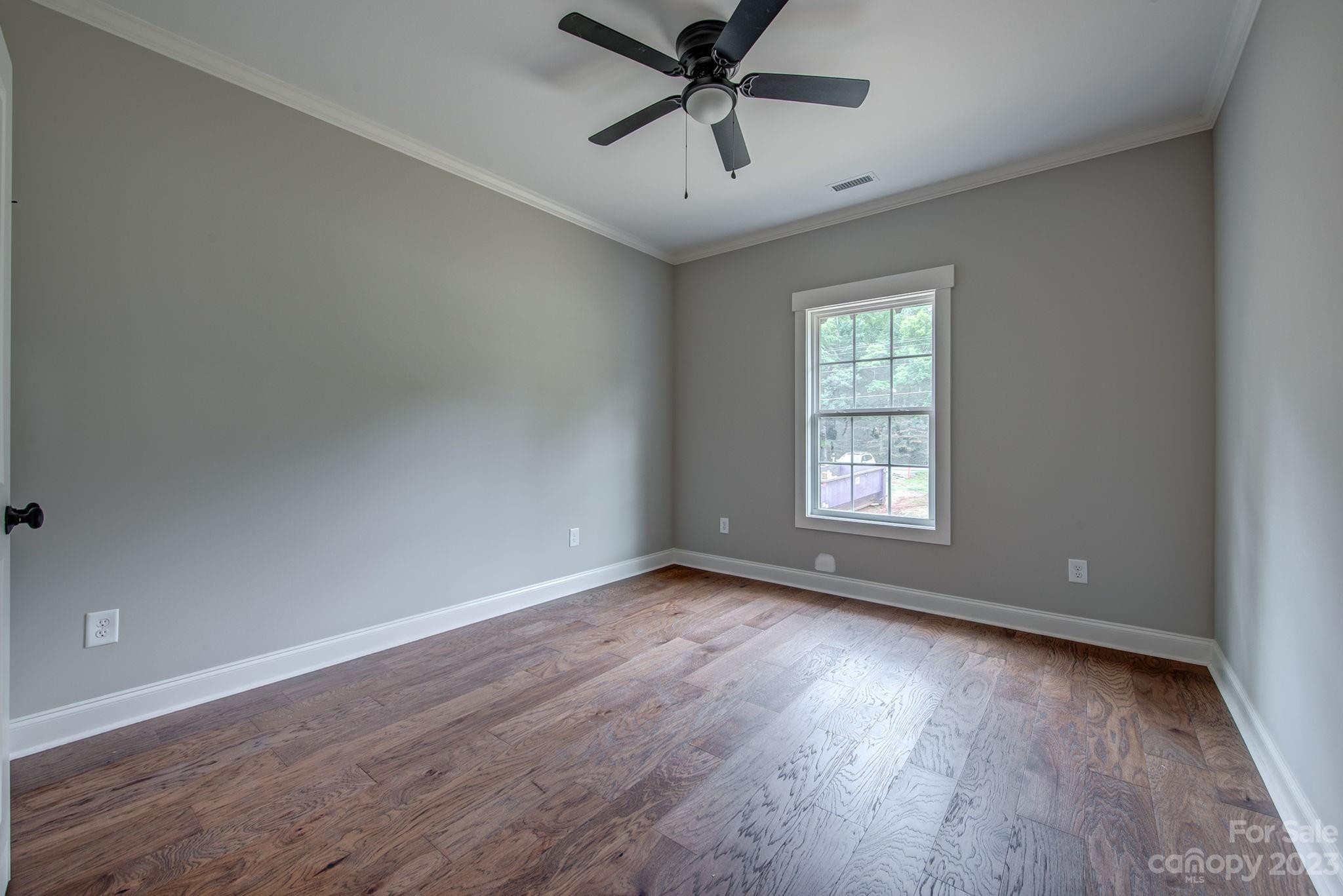 2911 Sparrow Springs Road Gastonia, NC 28052 - Photo 24 of 31 an empty room with wooden floor fan and windows
